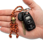 Full image of the Keychain hooked on a set of keys held in hand.